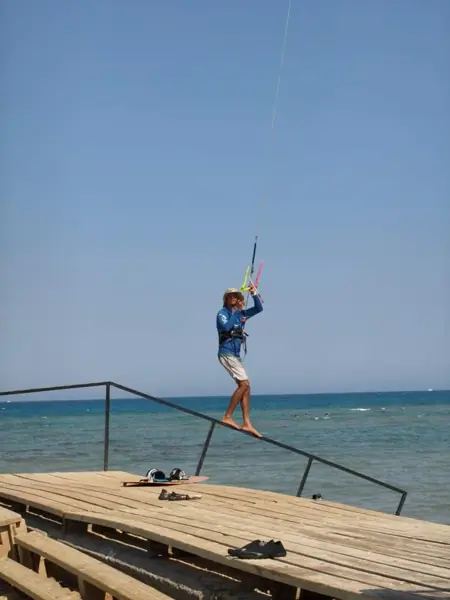 Instructor flying a kite on the wooden deck