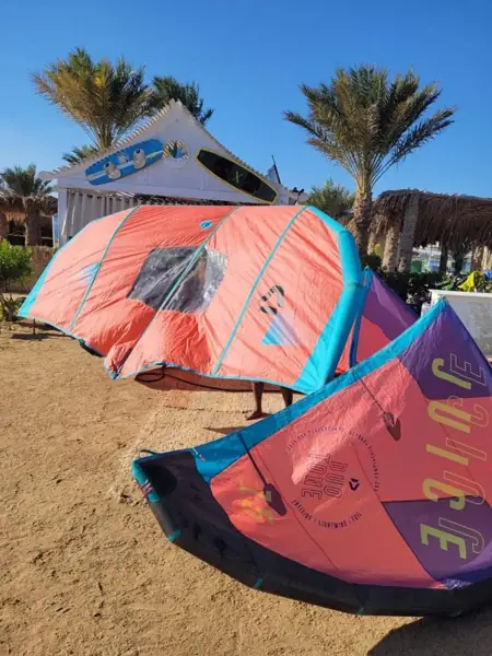 Wings and kites on the beach by the school hut