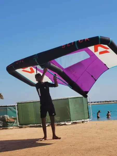 Instructor holding a purple wing