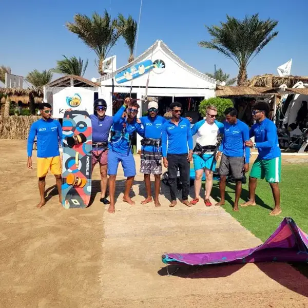 The Kite Fly team in front of the school on the beach