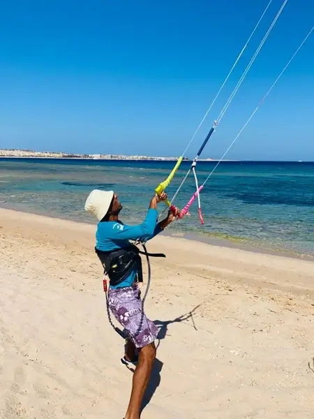 Instructor flying a kite on the beach