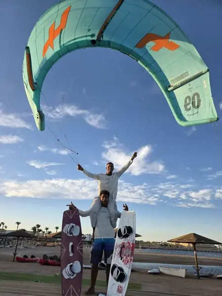 Instructors holding a kite over the beach